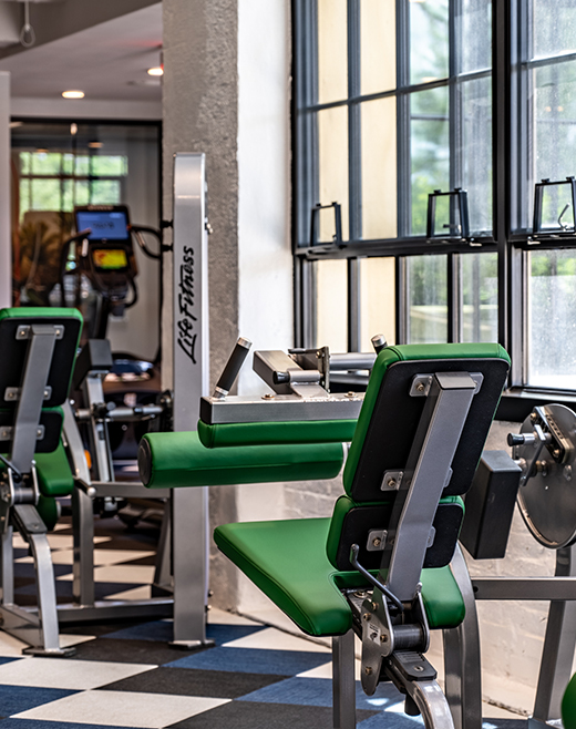 Leg press machines in an indoor gym with tile floors