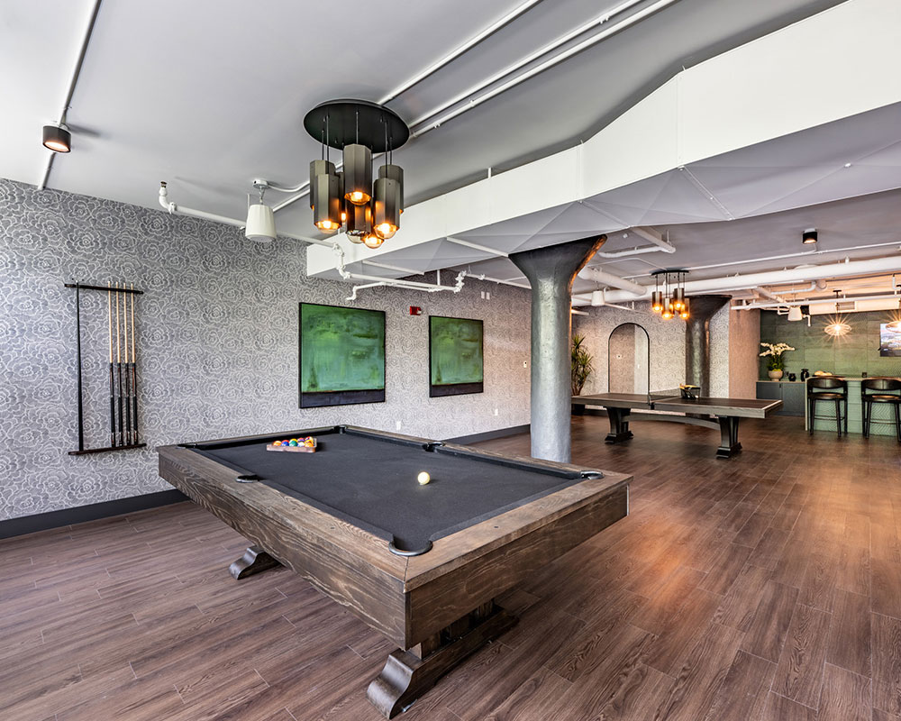 Game room with hardwood floors and pool tables