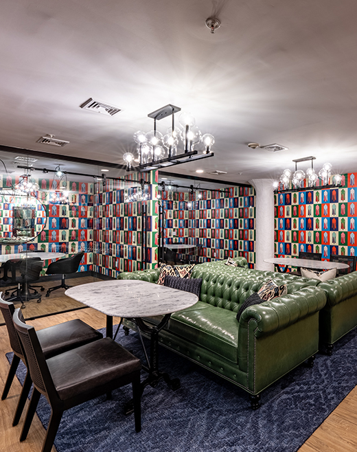 Sitting area with colorful wallpaper and leather furniture