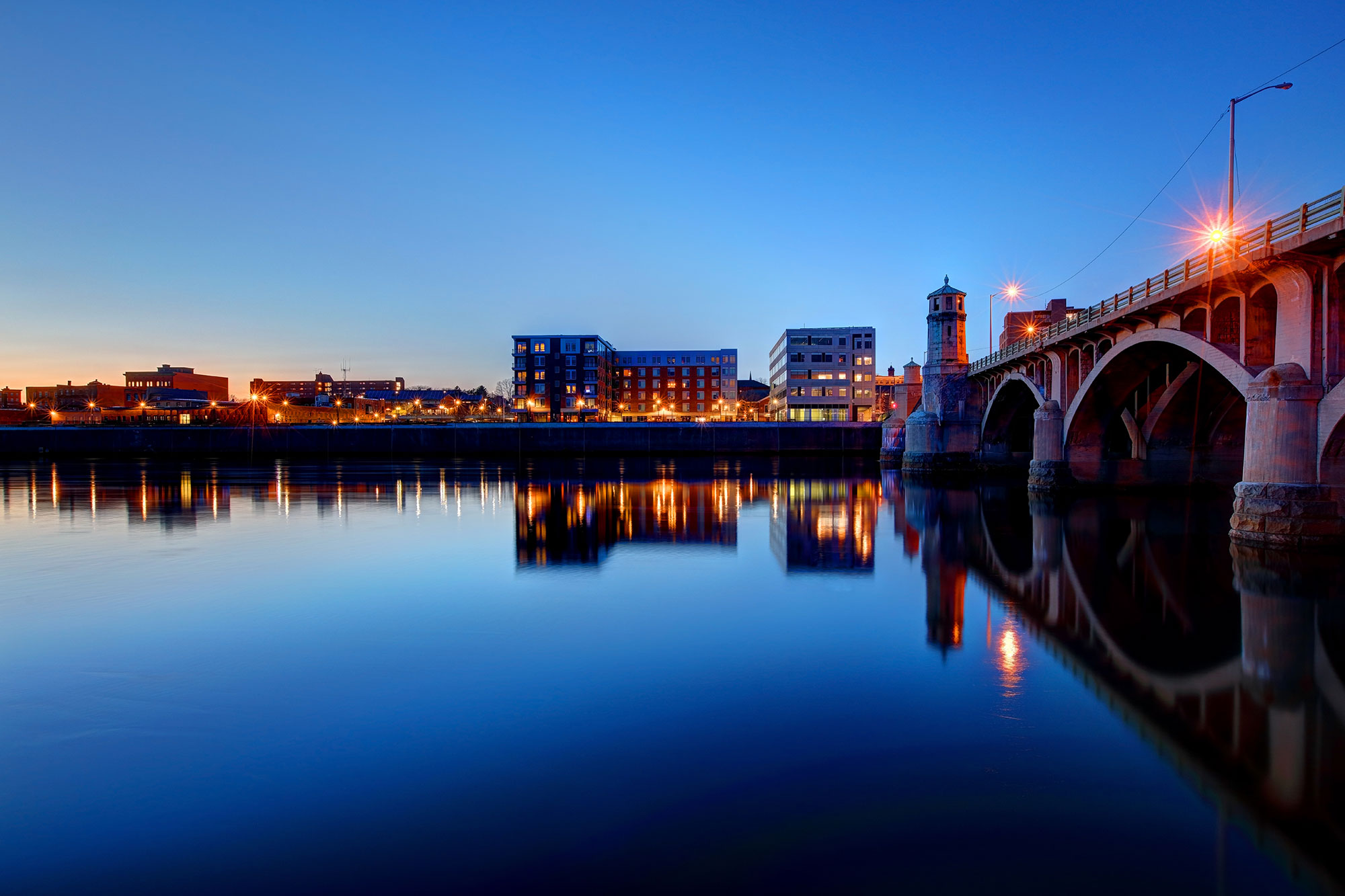 Brick bridge overlooking water at dusk