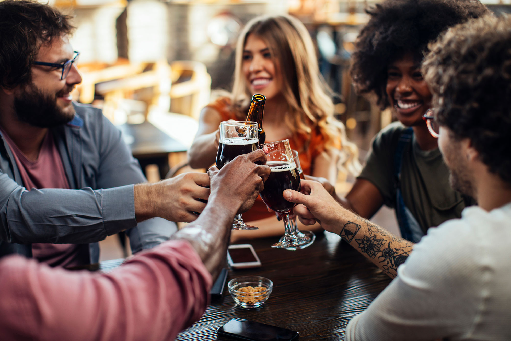 4 friends cheers together at a table